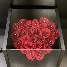 Heart-shaped box filled with red roses