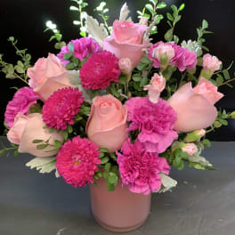 Pink roses and magenta carnations in a pink vase