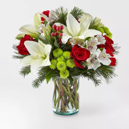 Bouquet of red roses and white lilies in a glass vase