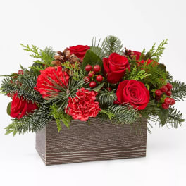 Red roses and carnations in a rectangular wooden box