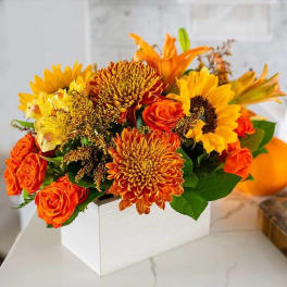 Orange and yellow bouquet in a white box