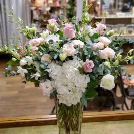Pink and white floral arrangement in a clear glass vase