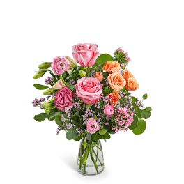 Pink and orange rose bouquet in a clear glass vase