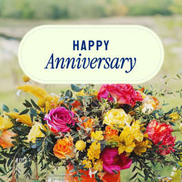 Colorful bouquet with roses and yellow flowers under a Happy Anniversary sign