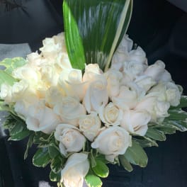 White rose bouquet with a large green leaf accent