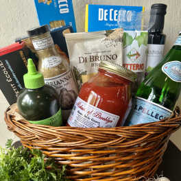 Gift basket with pasta, sauce, cheese, olive oil, and sparkling water