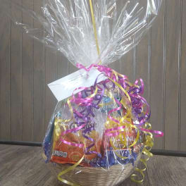 Gift basket with assorted snacks wrapped in clear cellophane and ribbon