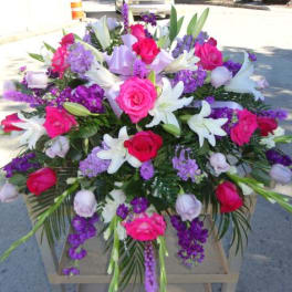 Large bouquet of pink roses and white lilies with purple flowers