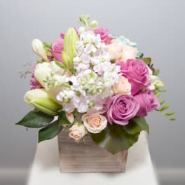 Pink and white rose bouquet in a wooden box