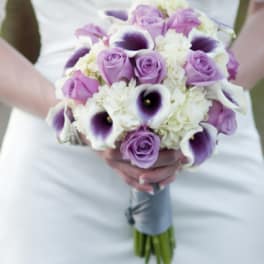Bridal bouquet of lavender roses, white hydrangeas, and purple calla lilies