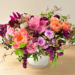 Pink and purple mixed bouquet in a white vase
