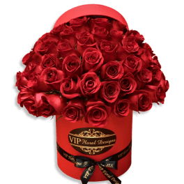 Red roses arranged in a red hatbox with a ribbon