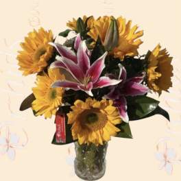 Bouquet of sunflowers and pink lilies in a glass vase