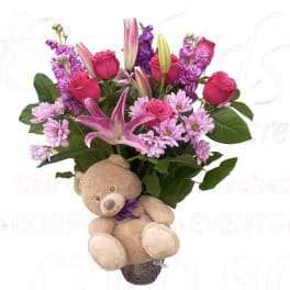 Pink and purple bouquet with a teddy bear attached