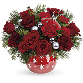 Red roses and carnations in a red ornament vase with silver baubles