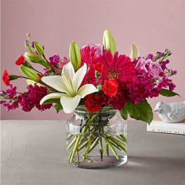 Pink and white mixed bouquet in a clear glass vase