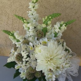 White floral arrangement with tall snapdragons and a large dahlia