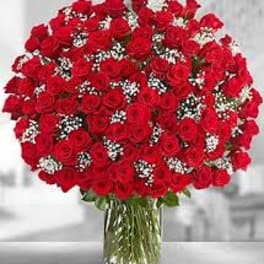 Large bouquet of red roses in a clear glass vase