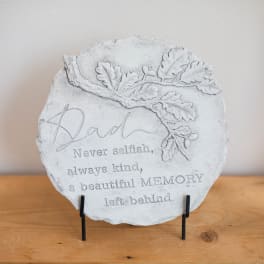 Memorial stone plaque with an oak leaf design and the word Dad