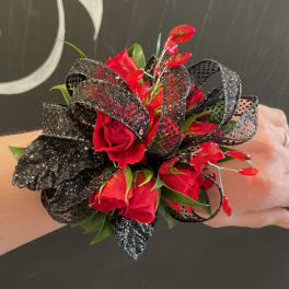 Red rose wrist corsage with black glitter ribbon and red accents