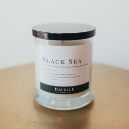 Black Sea candle in a glass jar with a black lid