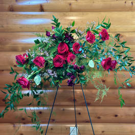 Cascade bouquet of hot pink roses with greenery on a stand