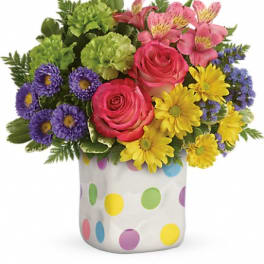 Colorful bouquet in a polka-dot ceramic vase