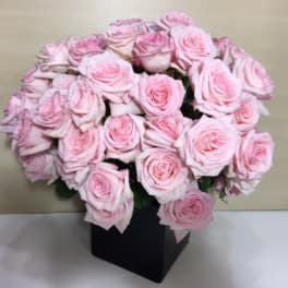 Bouquet of pale pink roses in a black box vase