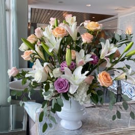 Large bouquet of roses and lilies in a white vase
