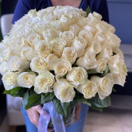 Large bouquet of white roses in a clear glass vase