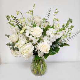 White floral arrangement in a clear glass vase