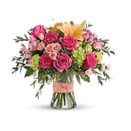 Pink rose bouquet with lilies in a glass vase