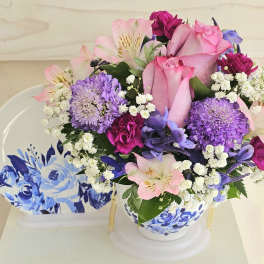 Pink and purple bouquet in a blue-and-white ceramic vase