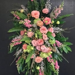 Large pink and green funeral spray with roses and lilies
