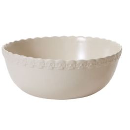 Cream-colored scalloped ceramic bowl with a decorative rim