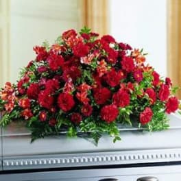 Large red floral spray on a casket