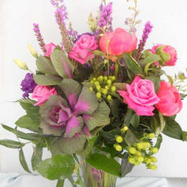 Pink and purple mixed bouquet in a clear glass vase