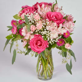 Pink roses and alstroemeria in a clear glass vase