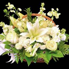 White floral basket arrangement with lilies and roses