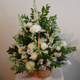 White floral arrangement in a woven basket