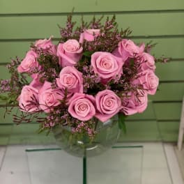 Pink roses arranged in a clear glass vase
