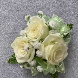 Small bouquet of cream roses with baby's breath and pale green ribbon