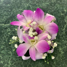 Pink and white orchid bouquet with small white filler flowers