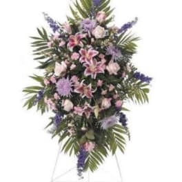 Standing floral spray with pink lilies and purple flowers