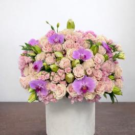 Pink rose and purple orchid arrangement in a white box