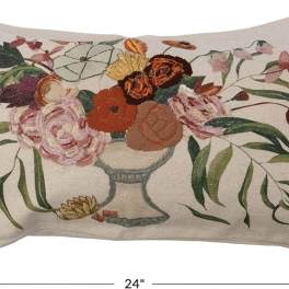 Floral embroidered pillow with a vase of mixed blooms