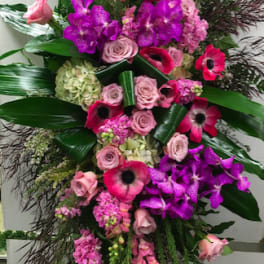 Tall standing floral spray with pink and purple blooms