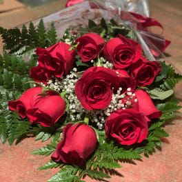 Bouquet of red roses with baby's breath and fern foliage