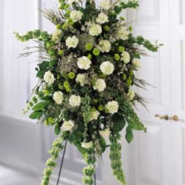 Tall white and green floral standing spray on an easel