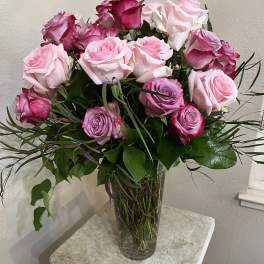 Bouquet of pink and white roses in a clear glass vase